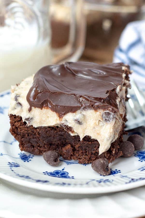 a cut cookie dough brownie sitting on a blue and white flower plate