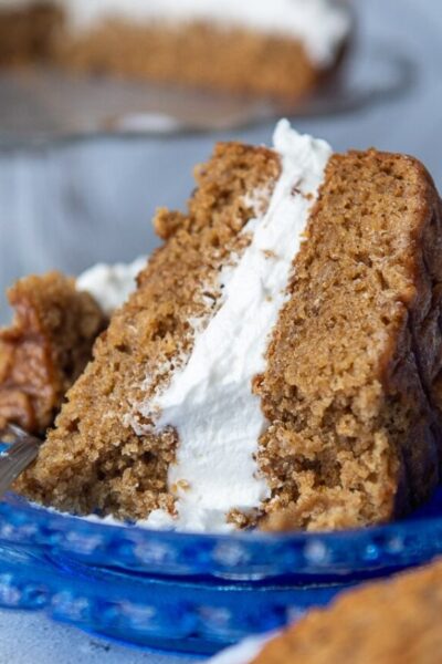 a slice of oatmeal cream pie cake on a blue plate with a bite taken out