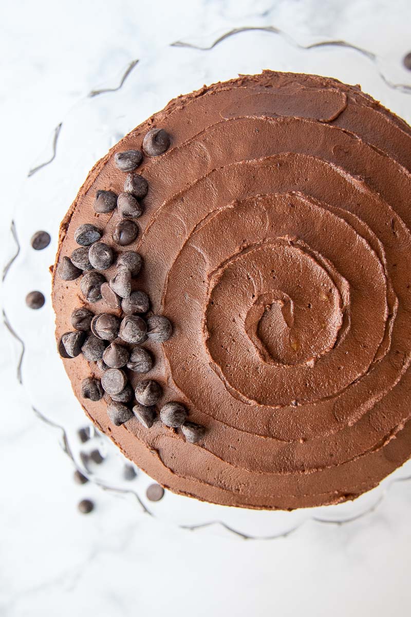 overhead view of a chocolate cake with chocolate chips decorating the top