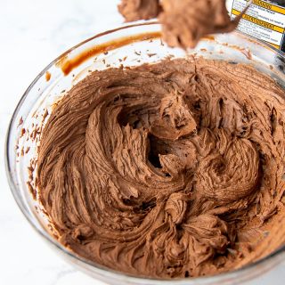 whipped chocolate ganache frosting in a mixing bowl