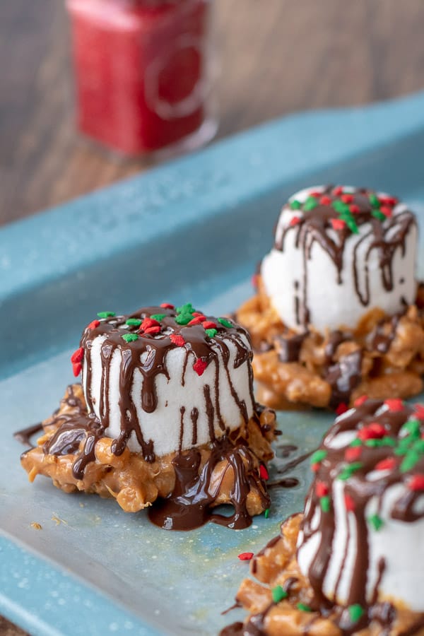 Caramel Marshmallow Treats on baking sheet with glistening drizzled chocolate