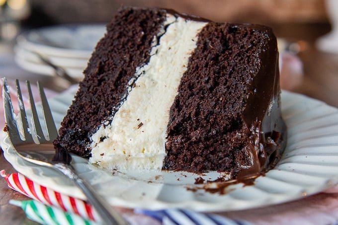 a piece of hostess ding dong layer cake on a white plate with a piece taken out