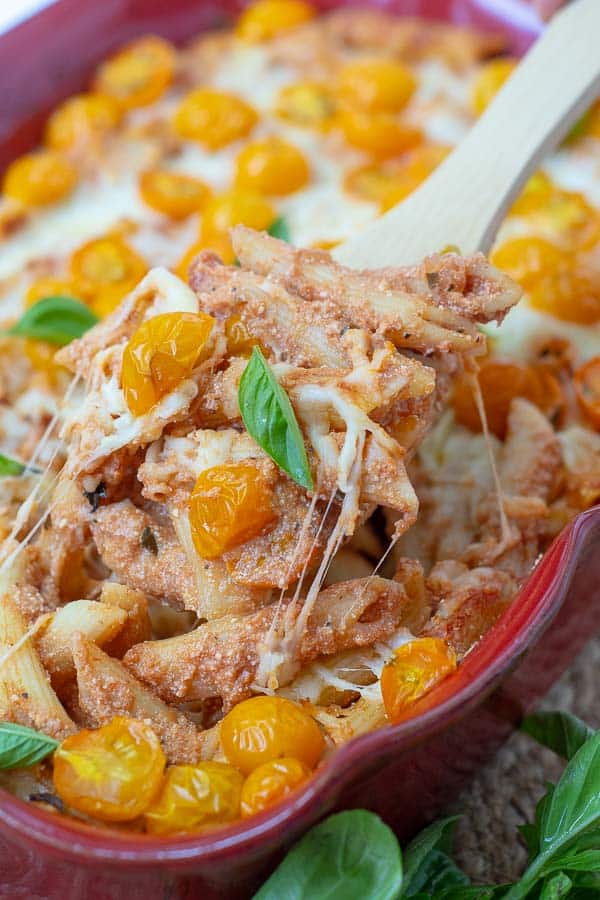 a wooden spoon scooping into easy baked pasta casserole
