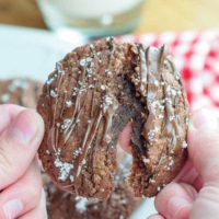 an easy Nutella cookie being held up and slightly pulled apart