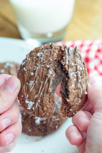 an easy Nutella cookie being held up and slightly pulled apart