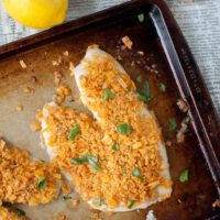 an overhead shot of oven fried fish on a baking sheet