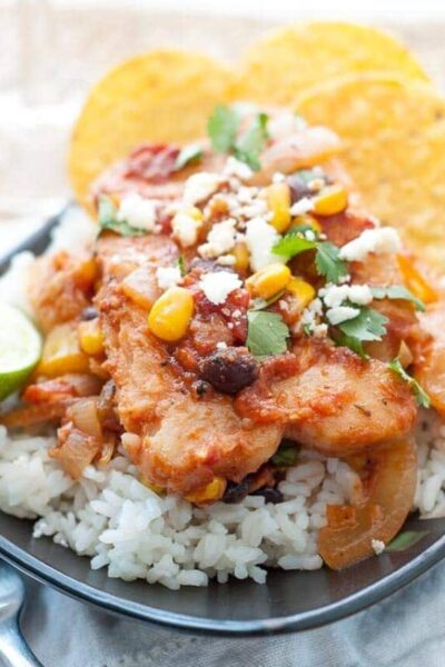 A plate of Healthy Weeknight Mexican Alaska Pollock Fish sitting on a bed of rice