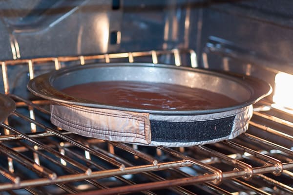 The chocolate cake layer being baked in an oven 