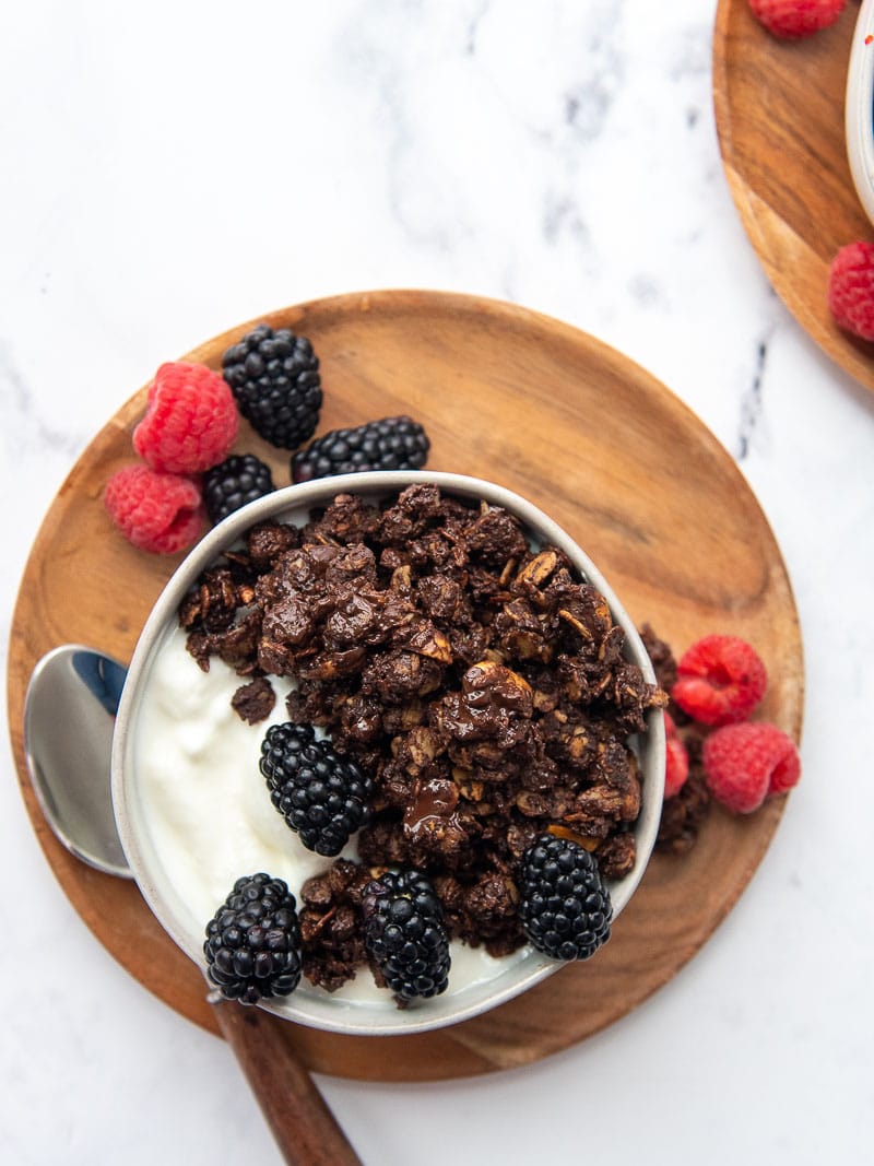 overhead shot of granola in a bowl with yogurt and berries