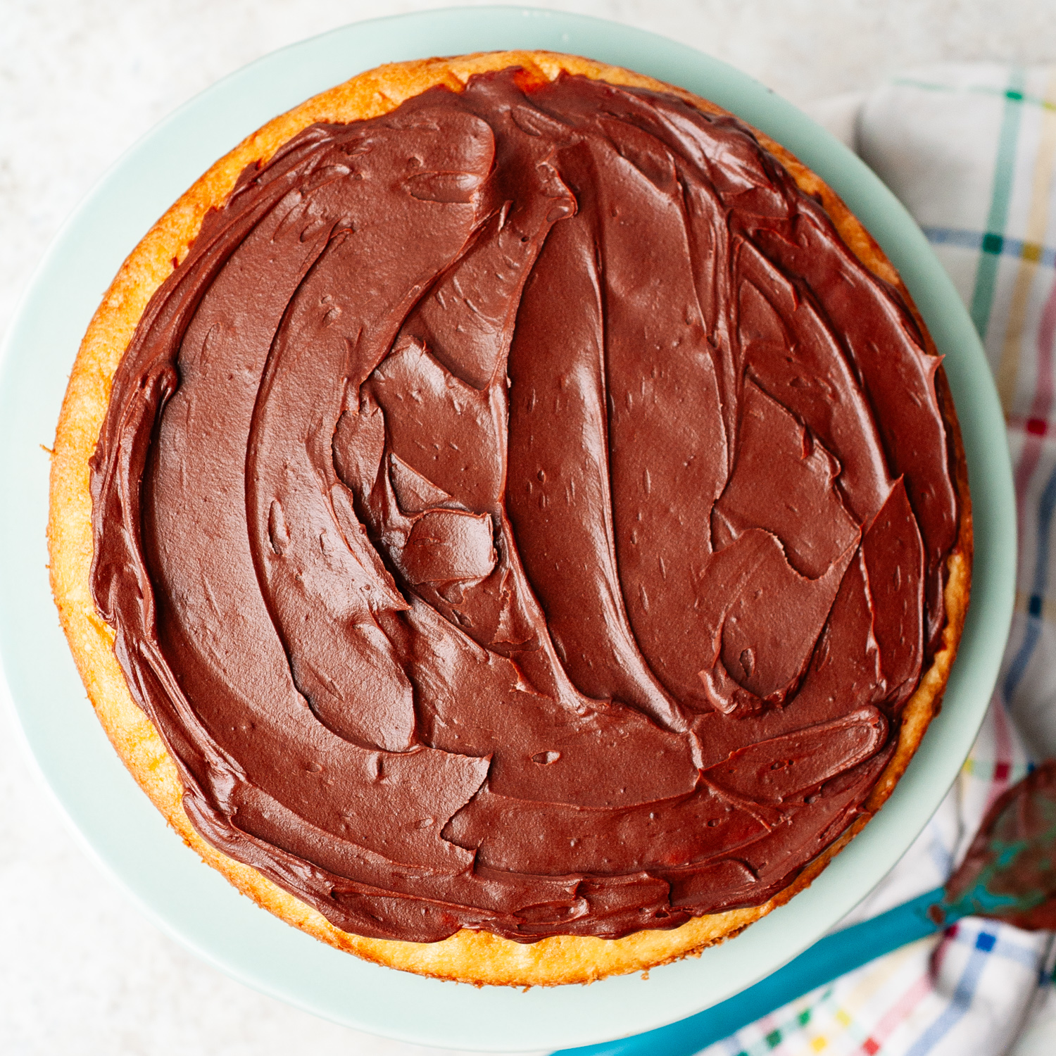 chocolate spread on a cake layer.