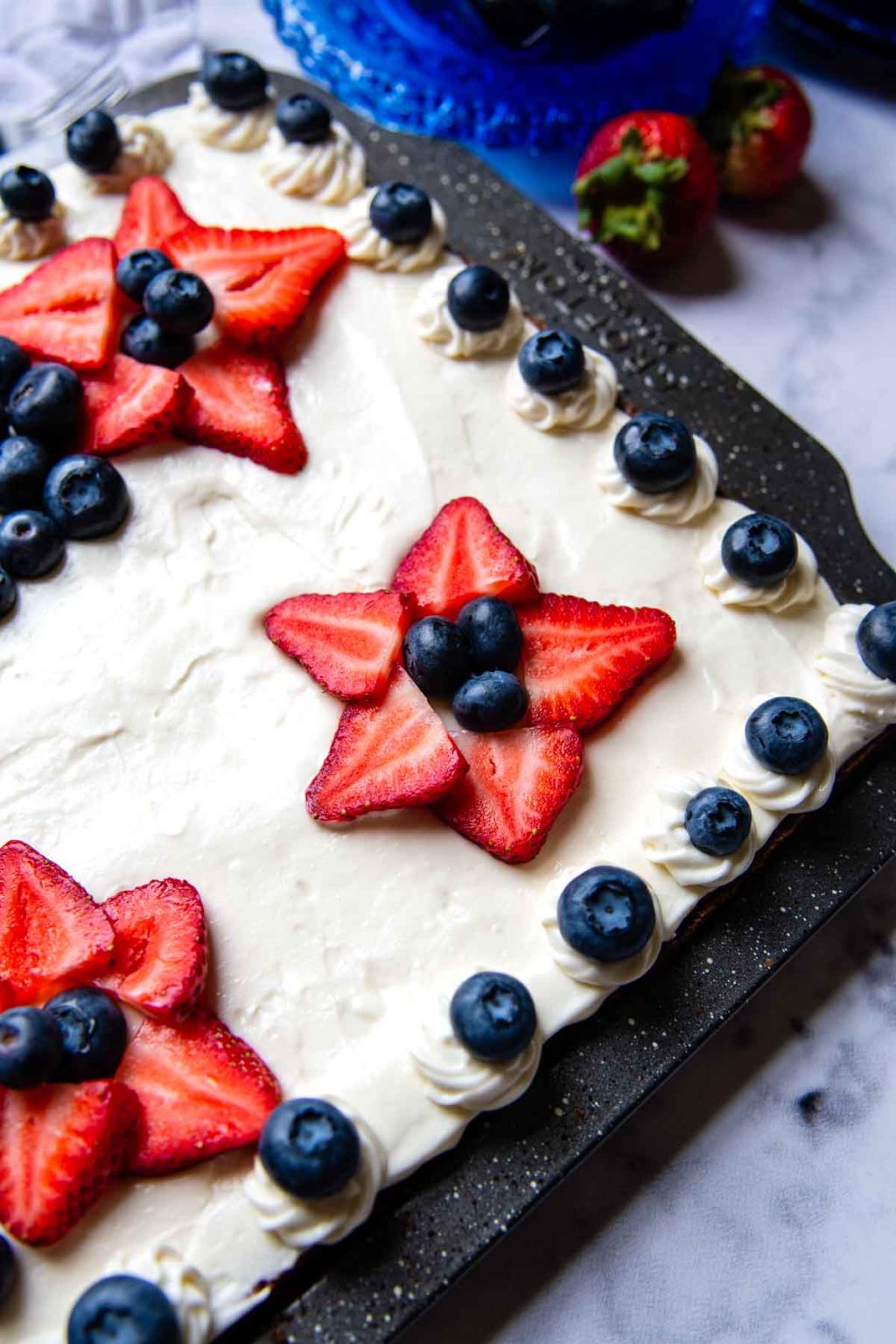 close up of strawberries slices forming stars with blueberry center