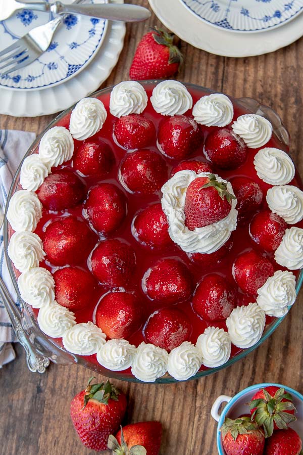 an overhead shot of no bake strawberry cheesecake with whipped cream dolloped on top