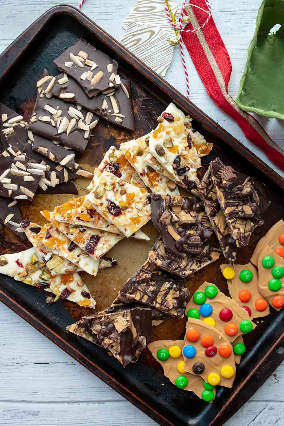 a baking sheet filled with different types of chocolate bark recipes
