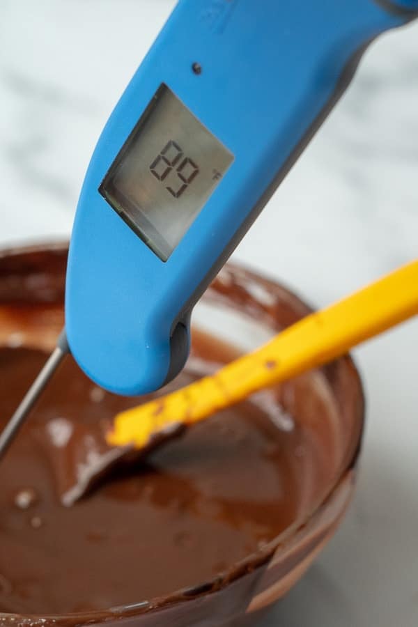 a thermometer measuring the temperature of tempered chocolate