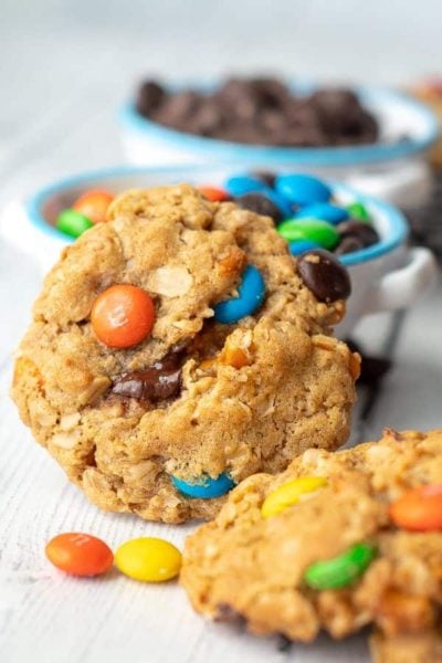 flourless kitchen sink cookie stood up by a bowl of m & ms