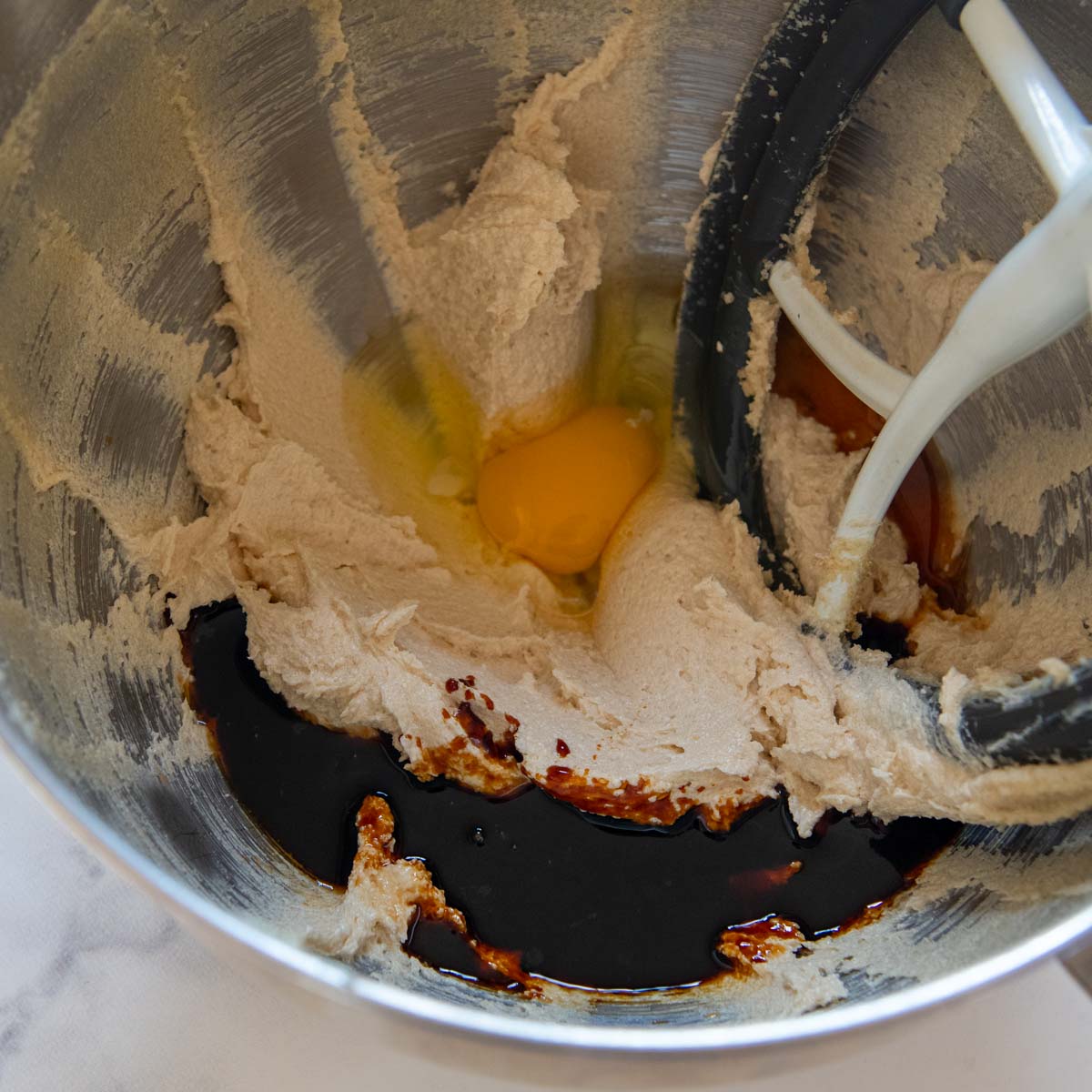 cookie dough with egg and molasses being mixed in.