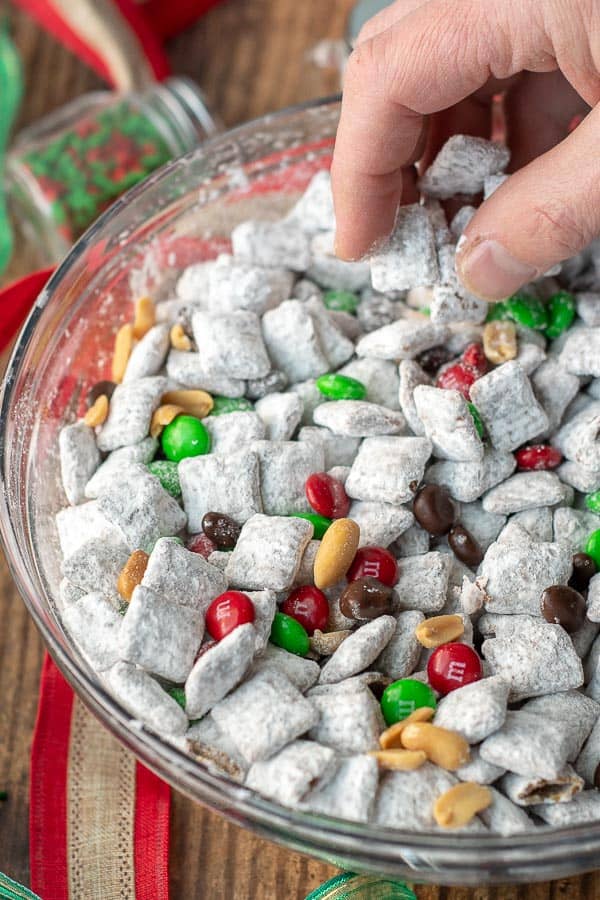 a hand scooping up some nutella reindeer puppy chow