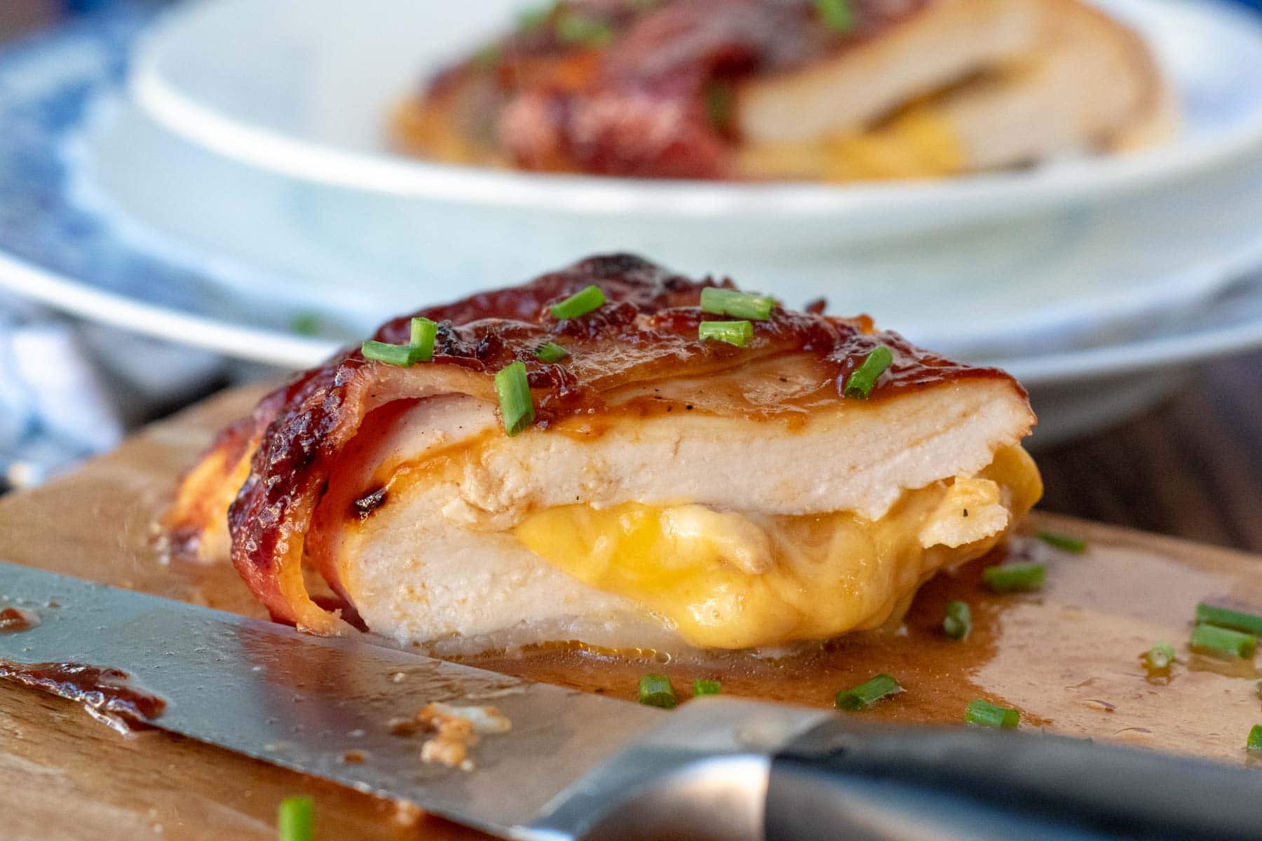 bacon wrapped chicken stuffed with cheese oozing out