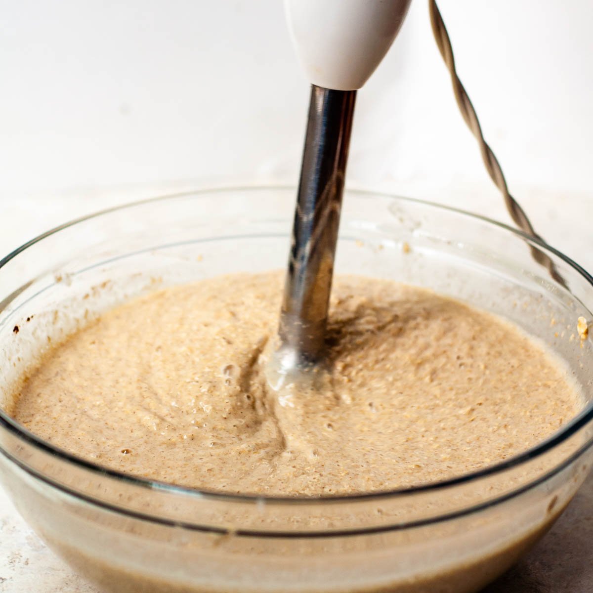 an immersion blender mixing together the pancake batter.