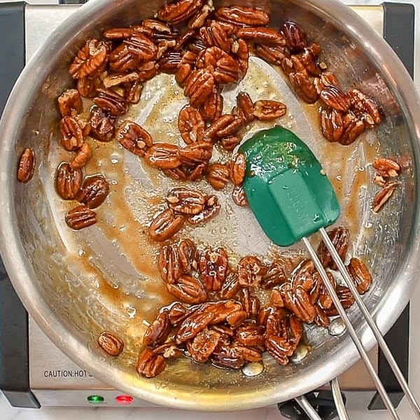 third step of how to make candied pecans - cook liquid down