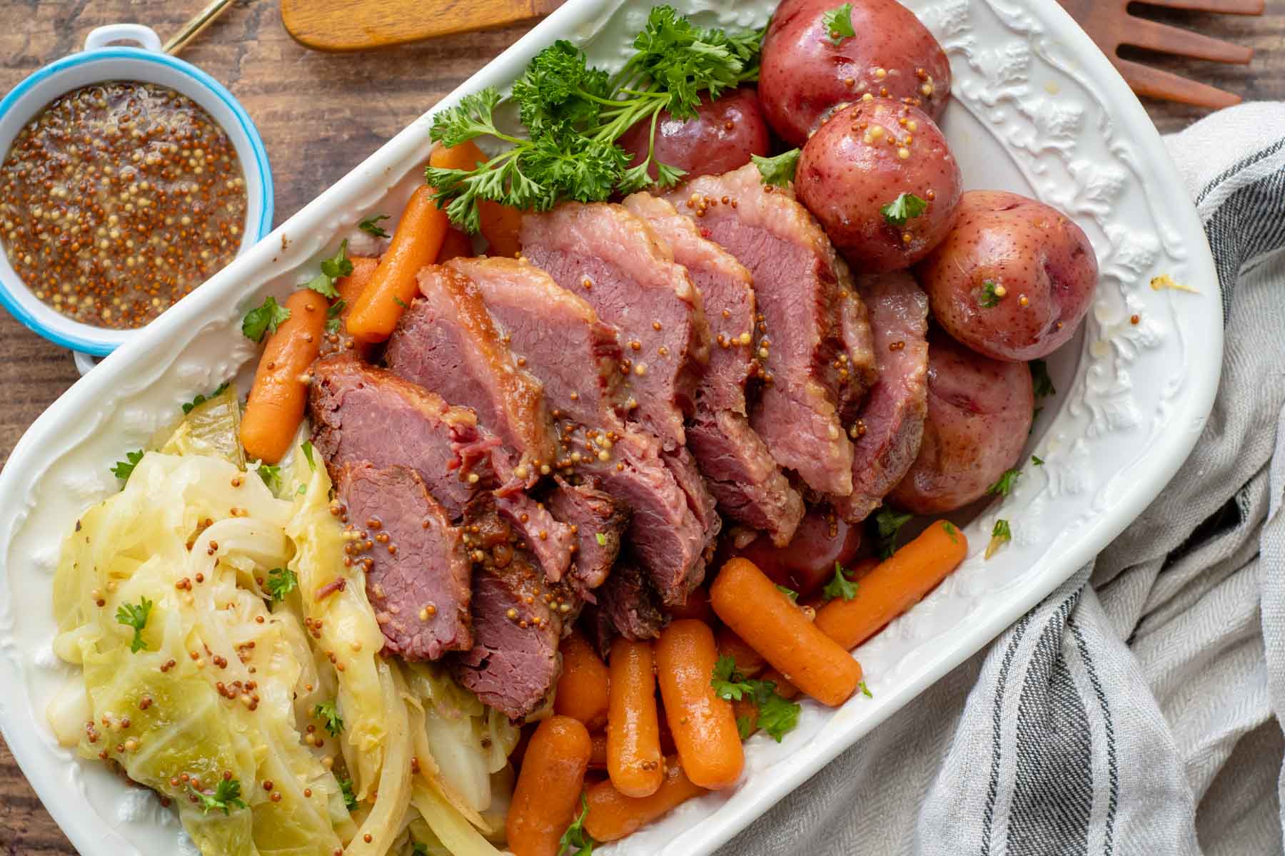 overhead shot of corned beef, cabbage, potatoes, carrots on a serving platter