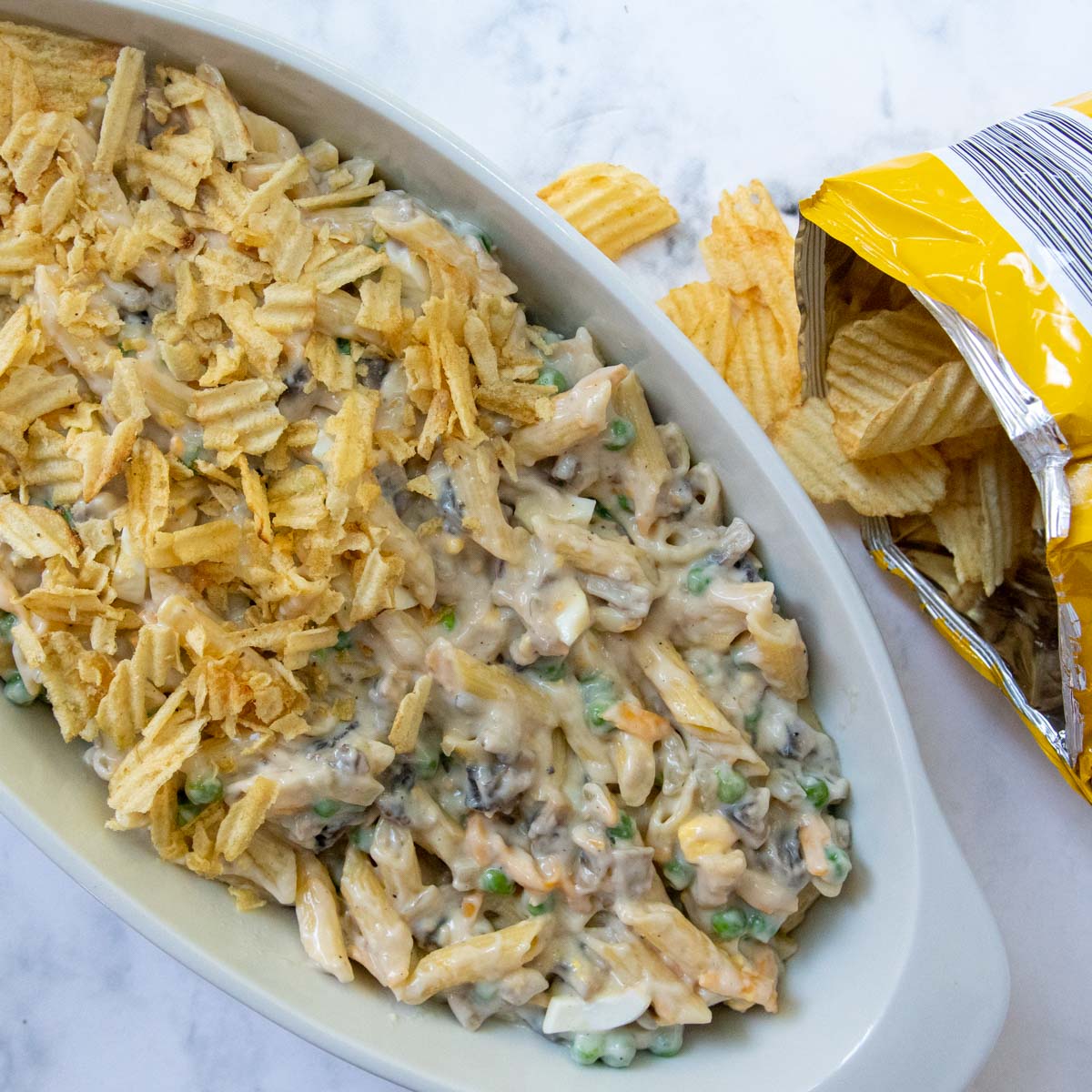 unbaked tuna casserole with potato chips on top and next to it