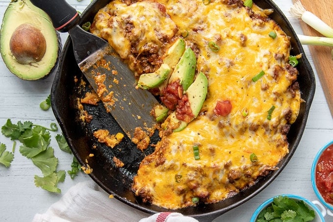 overhead shot of tamale pie casserole with a slice cut out and a serving spatula resting in the pan
