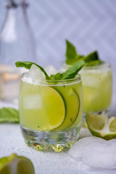 a cocktail glass with fresh lime slices showing through the side of the glass