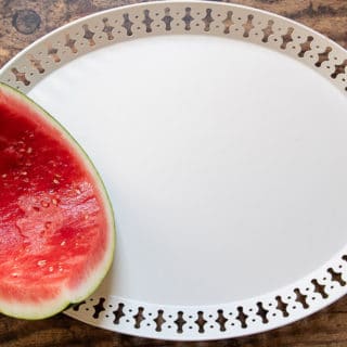 first step of how to make a dessert plate - placing a hollowed out watermelon
