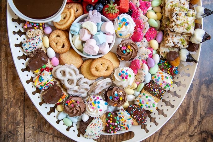 a close up on how the cookies and sweets are arranged on the dessert platter
