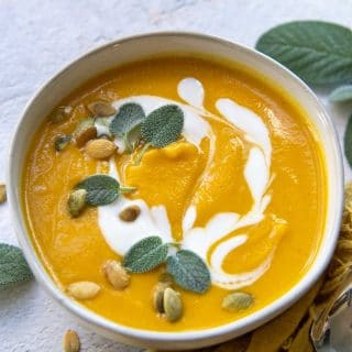 butternut squash soup swirled with coconut milk and fresh sage leaves