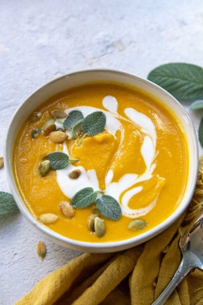 butternut squash soup swirled with coconut milk and fresh sage leaves