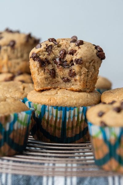 a chocolate chip almond flour muffin with a bite taken out and stacked on another muffin