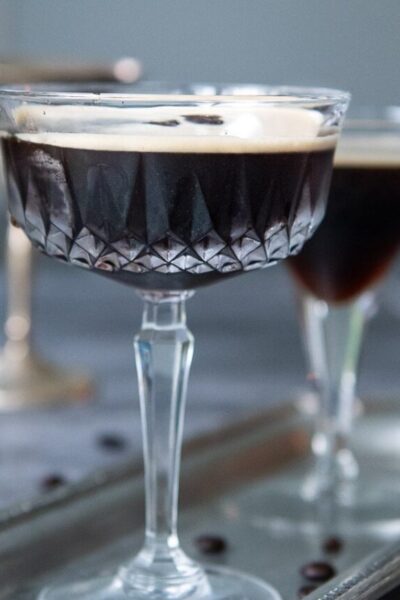 a straight on shot of espresso martini on a silver tray