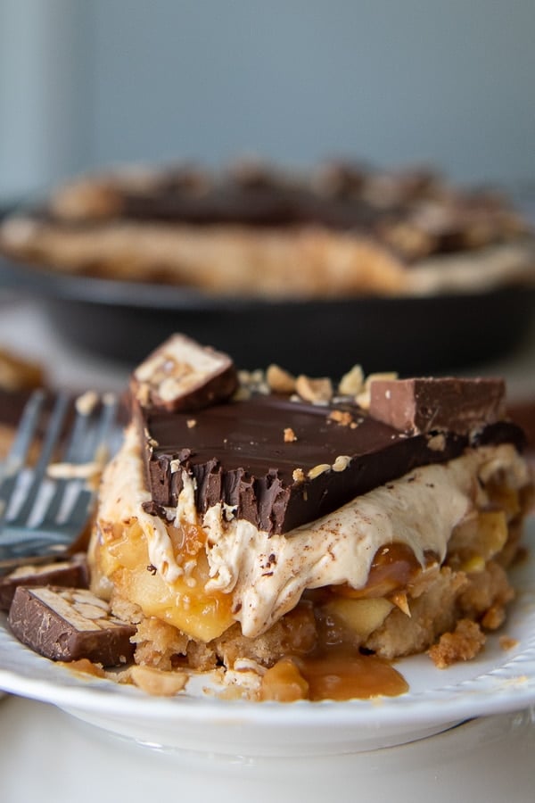 a close up shot of snickers pie with a bite taken out