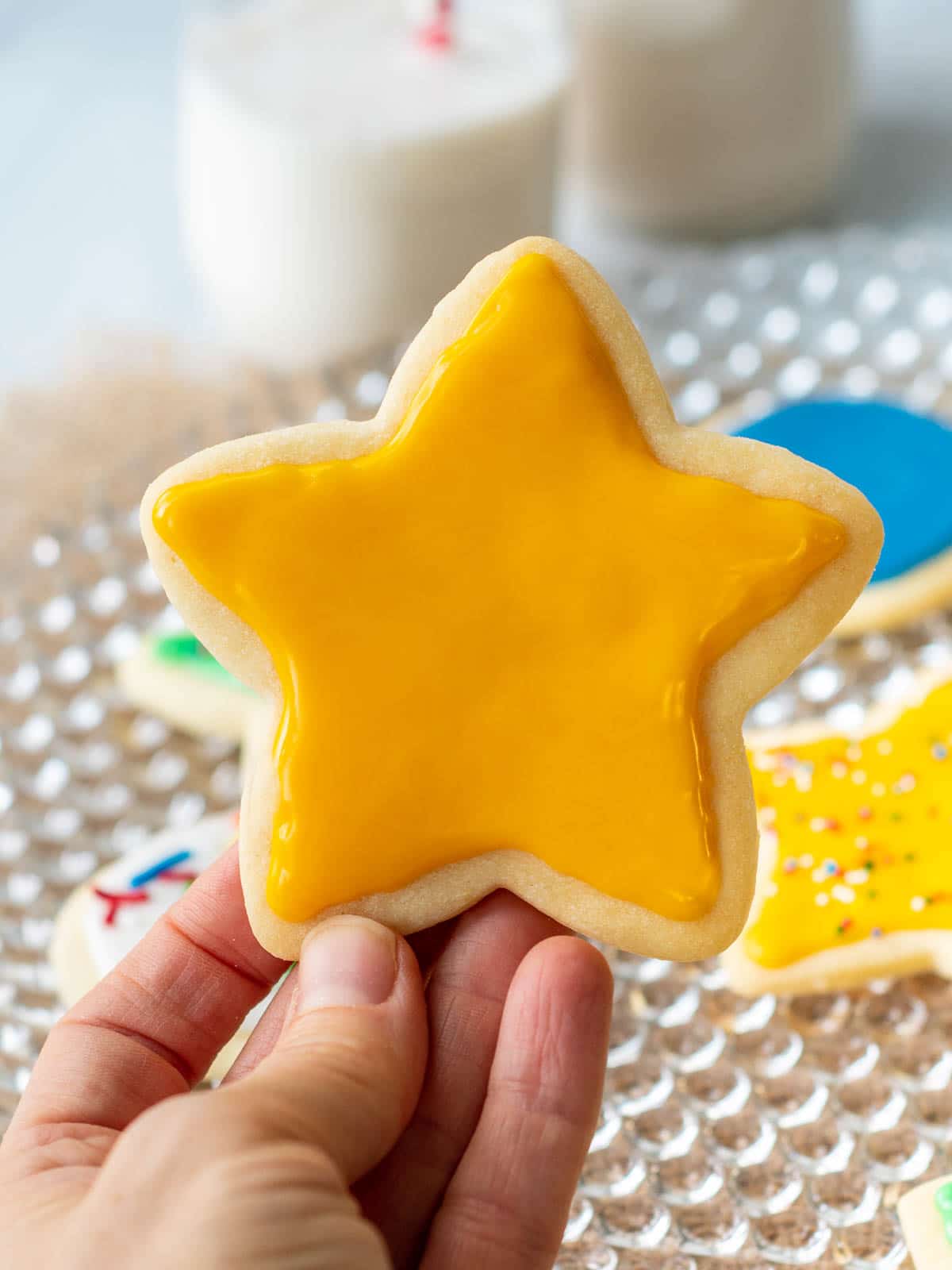 a yellow star cookie being held up
