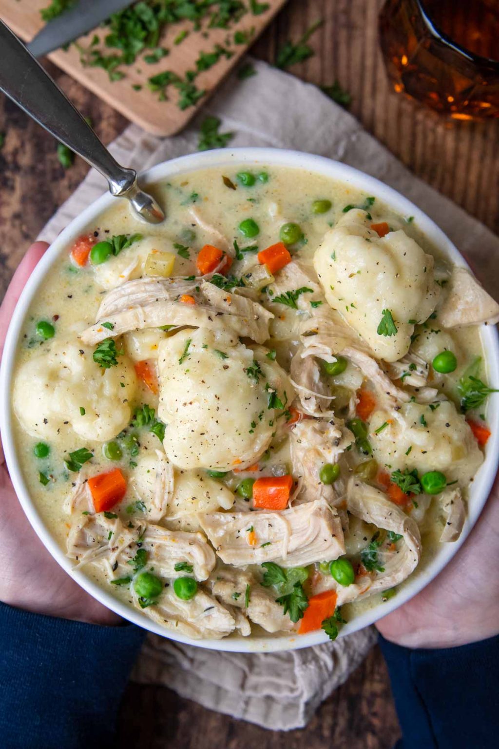 overhead shot of chicken and dumplings in a white bowl