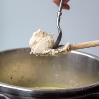 a small spoon scraping off dumpling dough into instant pot
