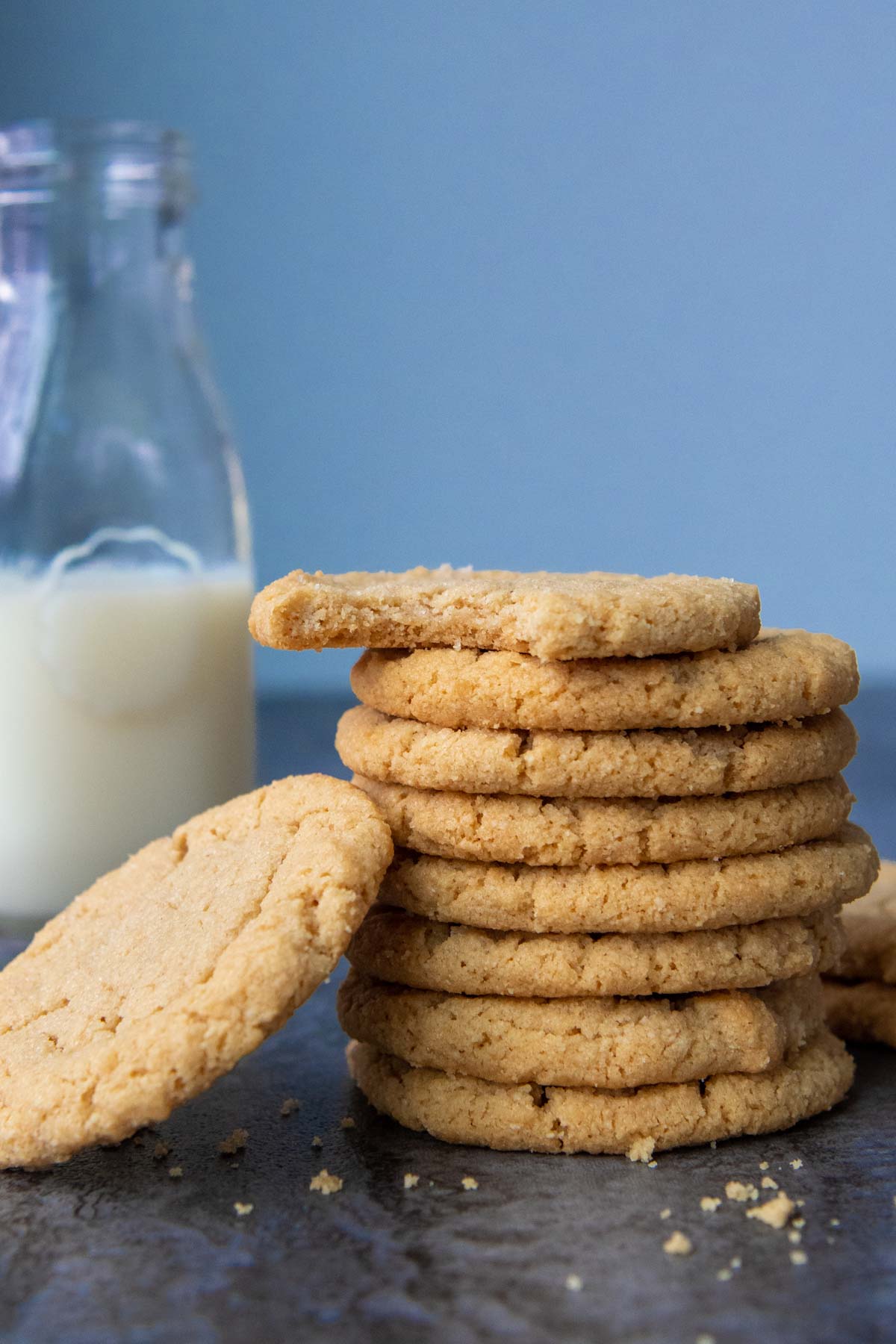 stack of peanut butter almond flour cookies next to a glass of milk