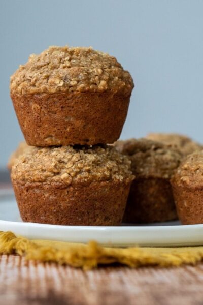 a stack of two applesauce muffins on a white plate