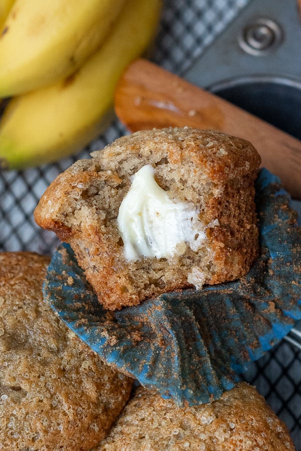 a bite taken out of a muffin with melted butter on it