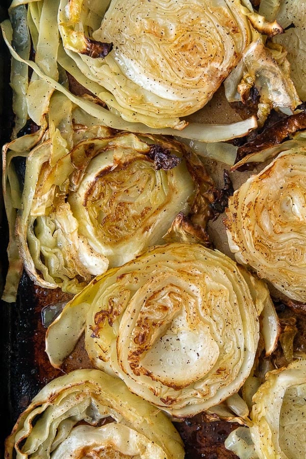 overhead shot of roasted cabbage on a baking sheet