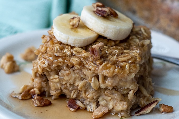 close up of amish oatmeal with banana slices and nuts on top