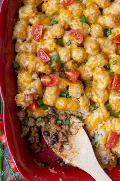 overhead shot of mexican tater tot casserole with a scoop taken out