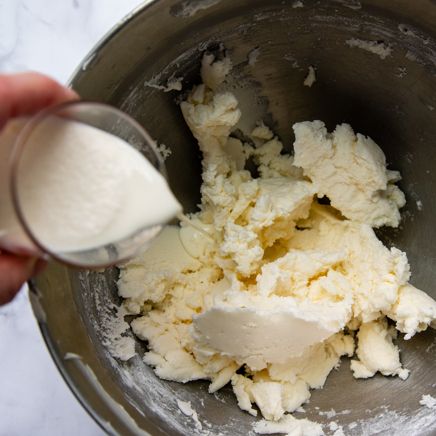 heavy cream added to the butter and powdered sugar mixture.
