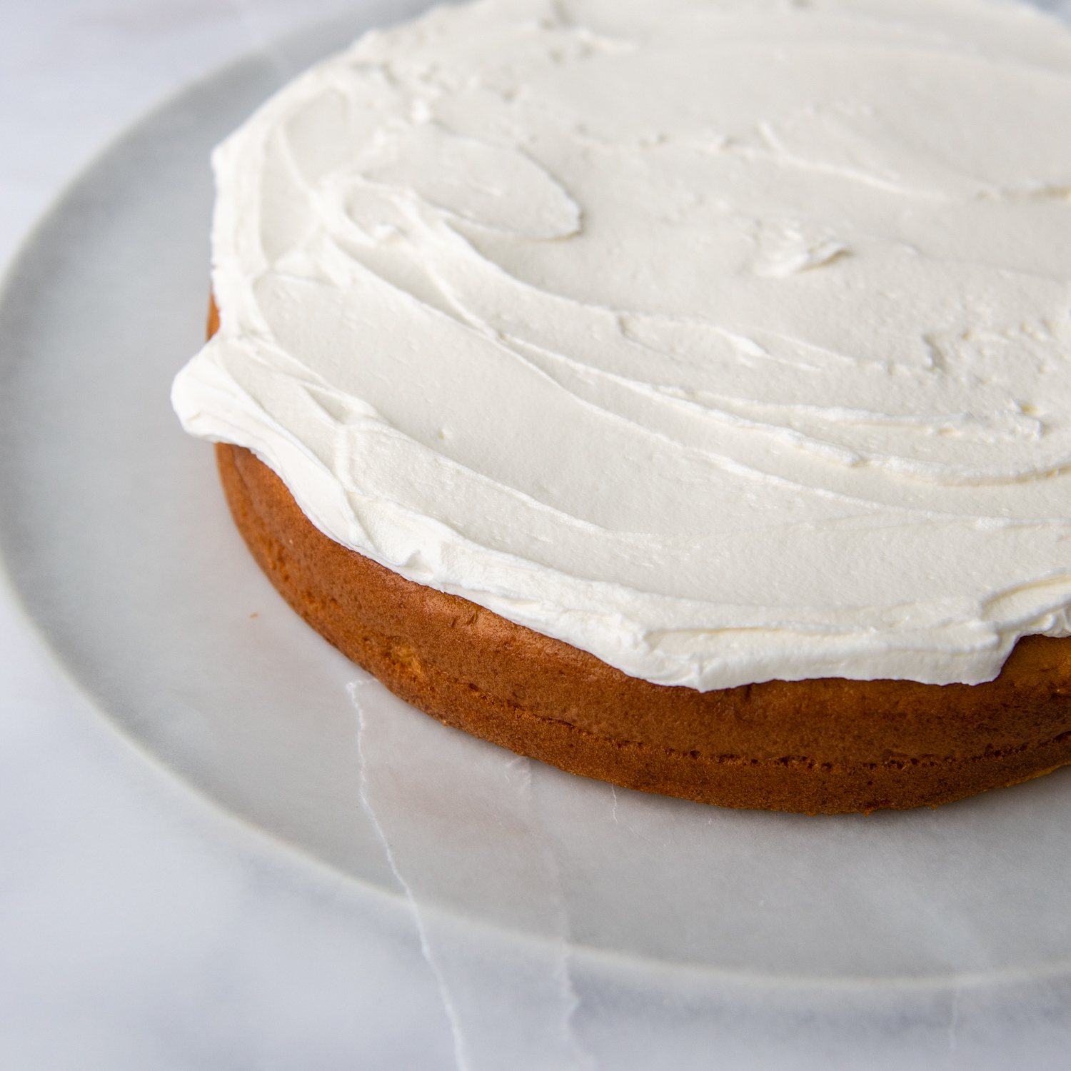 first layer of cake frosted.