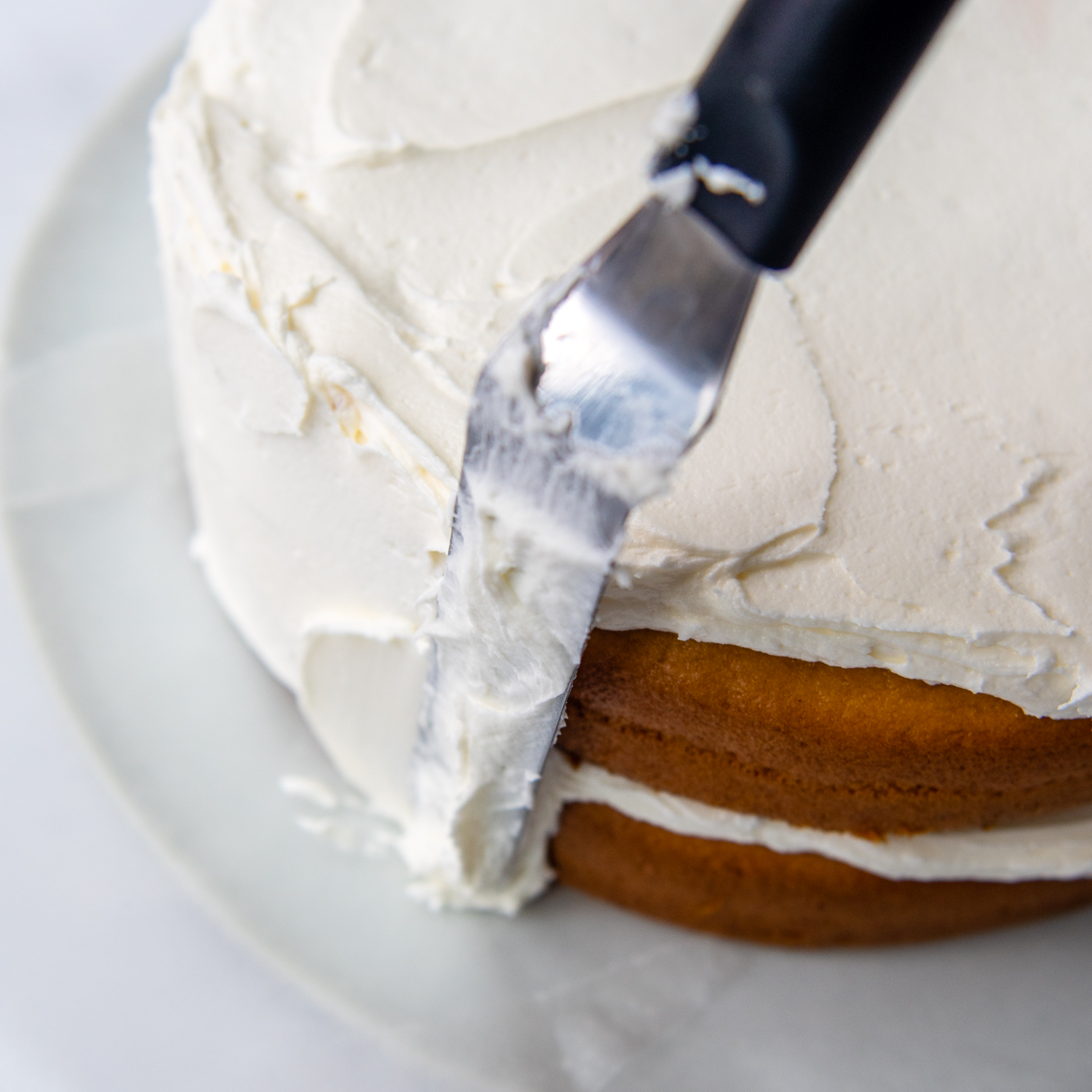 an offset spatula smoothing out the sides.