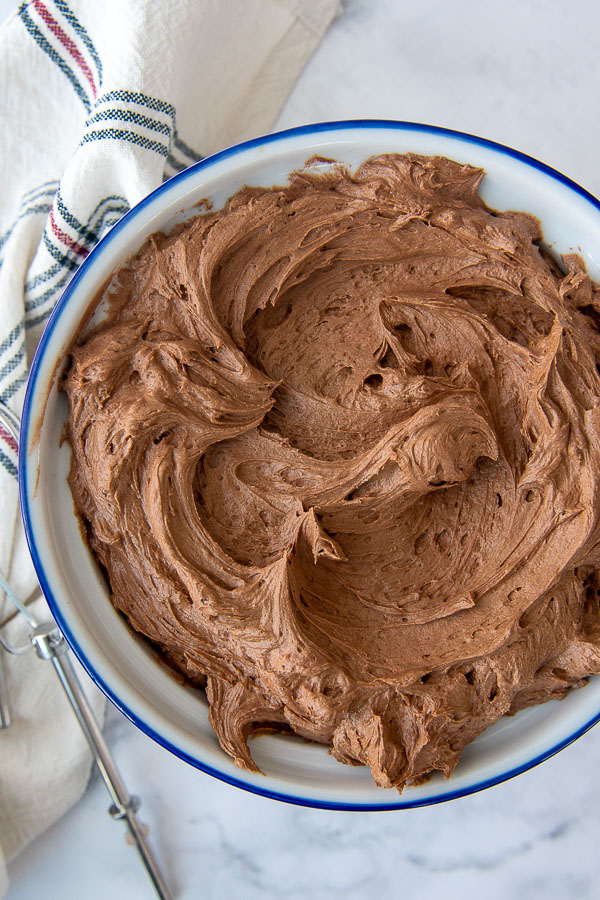 overhead shot of chocolate frosting in a white bowl