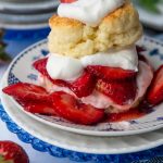 gluten free shortcake on top of fresh strawberries and whipped cream