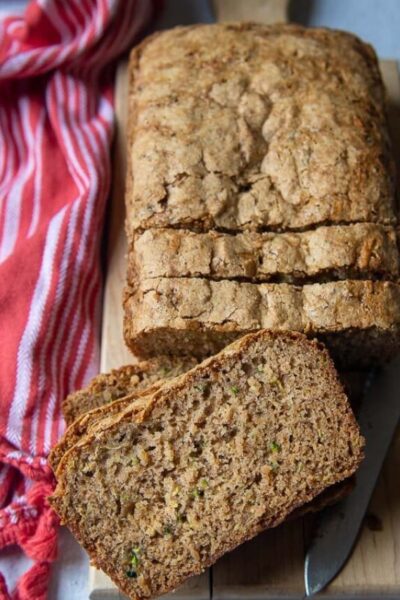 ovehead shot of sliced zucchini bread with a slice facing up towards the cameral
